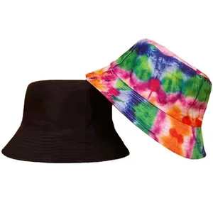 Detailed view of two reversible bucket hats in black and colorful tie-dye patterns.