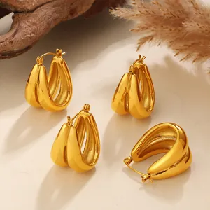 Elegant twisted C-shaped gold hoop earrings with minimalist geometric design