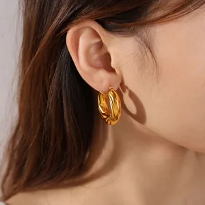 Minimalist gold twisted C-shape hoop earrings for women with elegant geometric design.