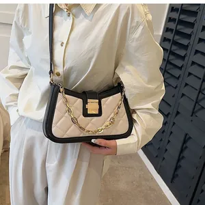 Quilted small crossbody bag with gold chain strap in beige and black fashion.