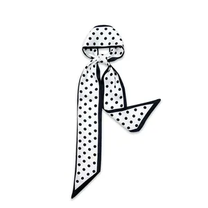 Detailed view of narrow white silk scarf with black polka dots and border