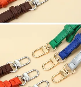 Detail of durable PU leather bag straps with high-quality metal lobster clasps.