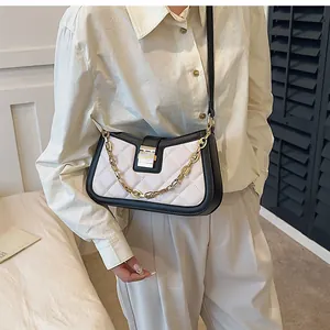 Stylish black and white quilted shoulder bag with elegant gold chain detail for women.