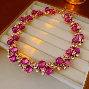 Detail view of a luxury vintage court style necklace with magenta stones and rhinestones