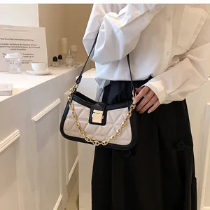 Stylish quilted underarm bag with gold chain strap in contrast colors.