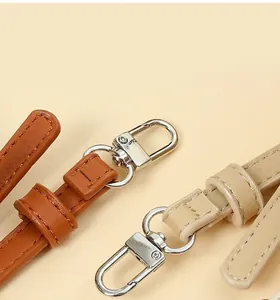 Detail of durable PU leather bag straps with high-quality silver metal swivel clasps.