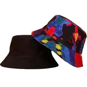 Detail of double-sided bucket hats featuring solid black and vibrant tie-dye patterns.
