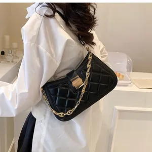 Detailed side view of elegant black quilted leather shoulder bag with gold chain strap