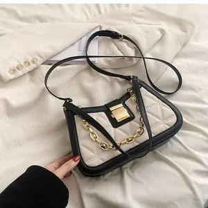 Elegant white quilted underarm bag featuring black contrast trim and gold chain detail
