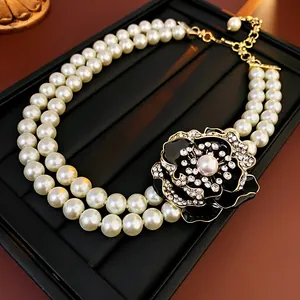 Elegant close-up of a vintage palace-style double pearl necklace with crystal flower pendant