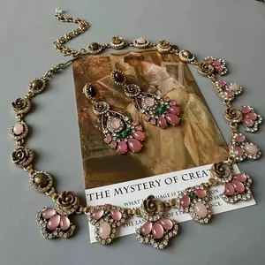 Vintage palace style jewelry set featuring pink stone necklace and drop earrings