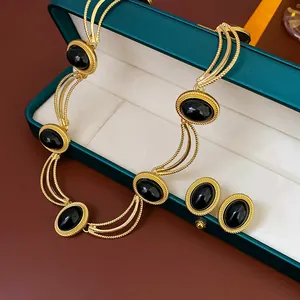Vintage palace style jewelry set with black oval stones and gold chain necklace