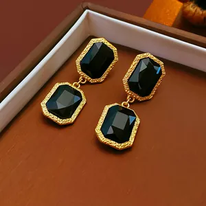 Elegant vintage court style dangle earrings with rectangular black stones in gold finish.