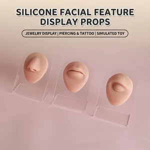 Detailed macro view of silicone nose, lip, and eye models for piercing practice display