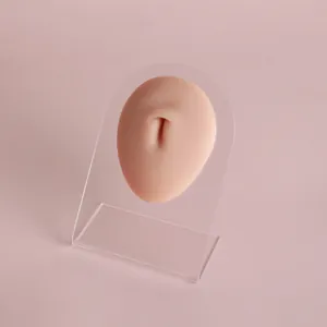 Realistic silicone navel model for piercing practice and jewelry display on clear stand