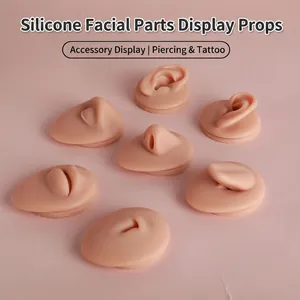 Realistic silicone facial feature models for body piercing practice and jewelry display.