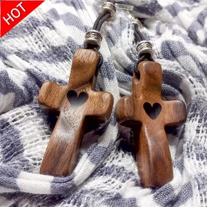 Handcrafted wooden cross pendant necklace featuring a decorative heart cutout design