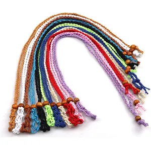 Detail of colorful hand-woven mesh necklace pouches with wooden beads for crystals
