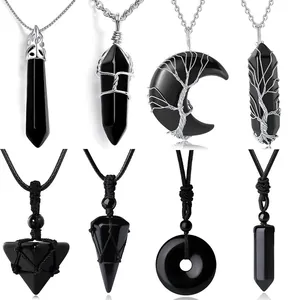 Detailed view of assorted black natural stone pendants with tree of life wire wrapping.
