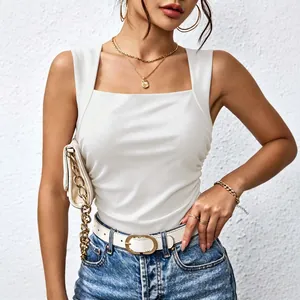 Close-up view of elegant white square neck sleeveless top styled with gold jewelry