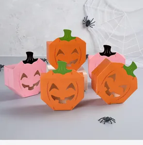 Detailed view of Halloween pumpkin-shaped candy boxes with hollow-out faces.