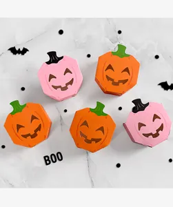 Details of Halloween pumpkin candy boxes with hollow funny face designs in pink and orange.