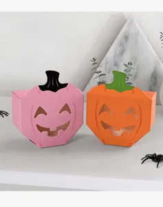 Detailed view of pink and orange Halloween pumpkin candy boxes with hollow smiling faces