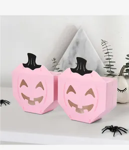Close-up view of pink Halloween pumpkin candy boxes featuring hollow funny expressions