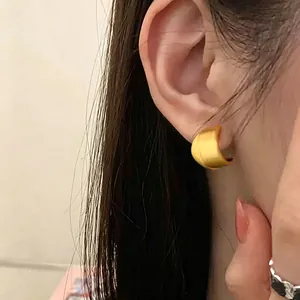 Minimalist matte brushed gold stud earrings with interlocking design in retro style