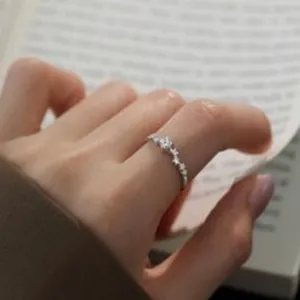 Close-up detail of s925 sterling silver ring featuring delicate starry sky star patterns