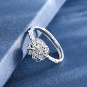 Detailed view of a shimmering S925 silver ring featuring a textured cushion-shaped top