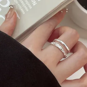 Macro detail showing a double-layered sparkling sterling silver ring with textured finish.