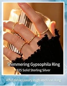 Macro detail of shimmering S925 sterling silver starry rings on female fingers