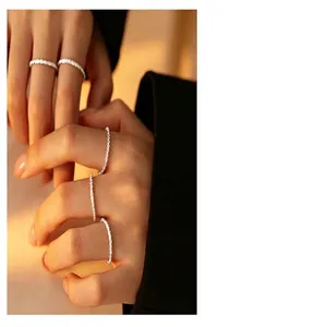 Detailed close-up view of s925 sterling silver wave chain rings stacked on fingers.
