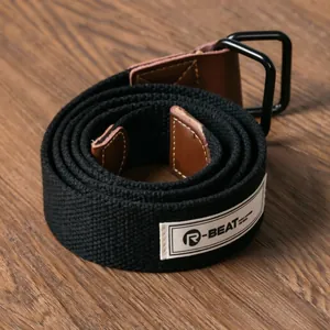 Close-up of black canvas belt featuring double D-ring buckle and woven R-BEAT label.