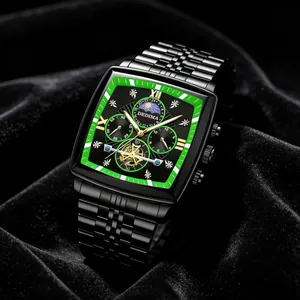 Close-up of black tonneau watch face with green bezel, moon phase and flywheel detail.