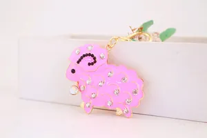 Detailed close-up of a pink rhinestone-studded sheep keychain with gold accents