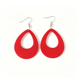 Detail view of minimalist bright red teardrop-shaped acrylic earrings for women