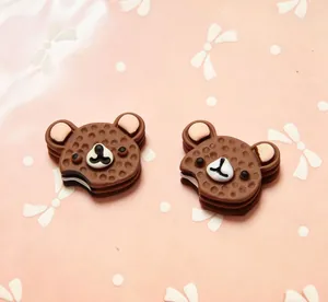 Close-up of bear-shaped chocolate cake resin accessories for DIY phone cases and hair clips
