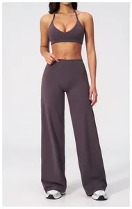 Full-length view of a mauve sports bra and high-waisted wide-leg athletic yoga pants