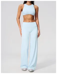 Detailed view of model wearing a light blue sports bra and matching wide-leg yoga pants