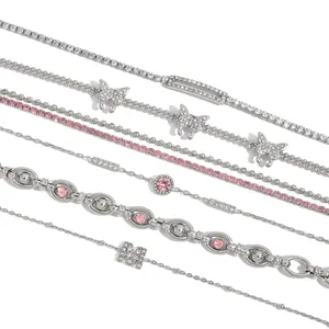 Set of six 18K gold-plated stainless steel bracelets with pink cubic zirconia details.