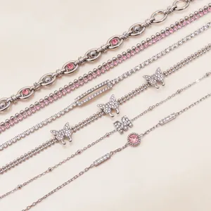 Detail shot of silver stainless steel bracelets featuring pink zircons and butterfly charms