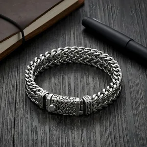 Detailed view of a men's heavy titanium steel dragon bone chain bracelet in punk style