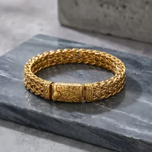Close-up of golden titanium steel wheat chain bracelet with intricate clasp design