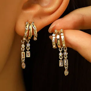 Stylish gold tassel hoop earrings with sparkling cubic zirconia for women's jewelry collection.