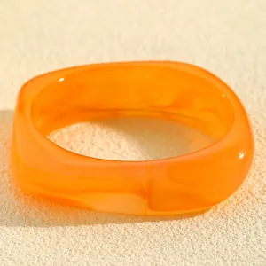 Vibrant orange marbled resin bangle with irregular geometric square design
