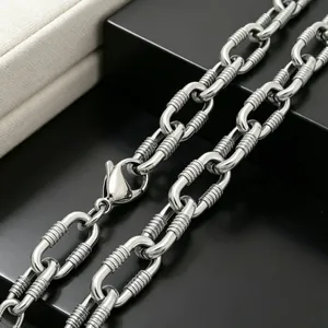 Macro detail of 10mm stainless steel link chain with unique horizontal grooved texture