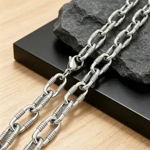 Close-up of thick stainless steel O-chain bracelet with textured horizontal stripes
