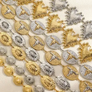 Detailed view of metallic ethnic style waist chains with bull head and heart link motifs